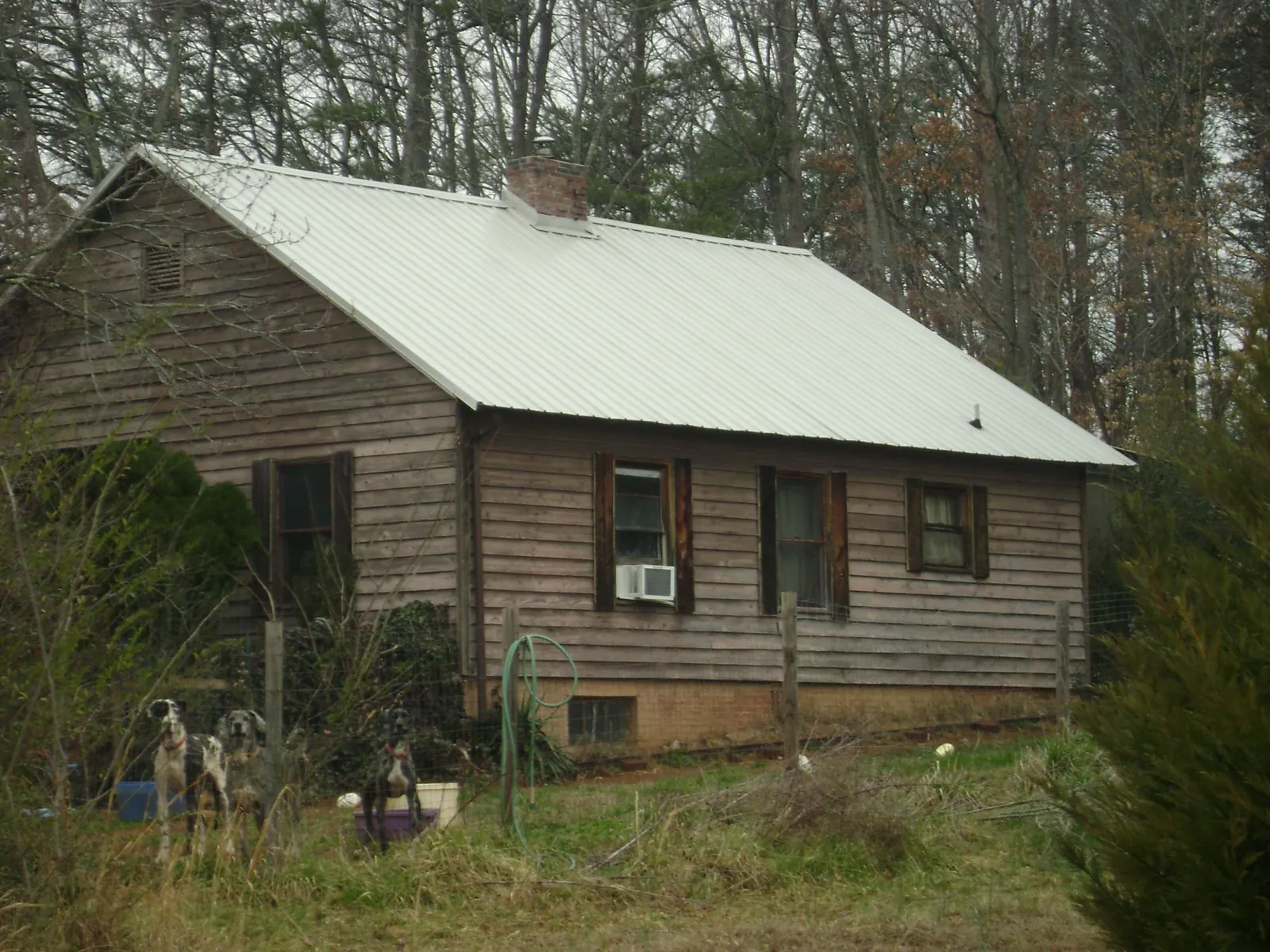 White metal roof on an old wood sided farmhouse, from a Metal Roof Installation job in Fayette